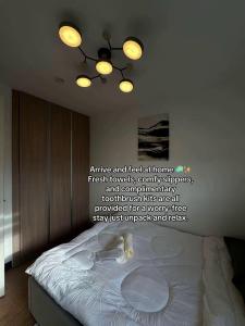 a bedroom with a bed with a quote on the wall at D'living Condotel in Davao City +19 photos