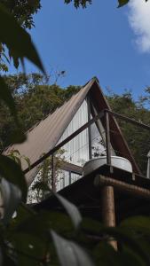 a house with a metal roof and some trees at Exclusive Huts in Gravatá
