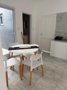 a dining room with a white table and white chairs at Saladillo House in Saladillo