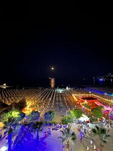 a crowd of people at a concert at night at Eri Apartments 2 in Shëngjin