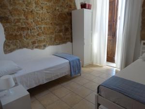 Postel nebo postele na pokoji v ubytování L'Arenaria Casa Vacanze