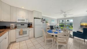 a kitchen and dining room with a table and appliances at Jamaica Royale #40 - 3 Heated Pools on the Beach! in Siesta Key