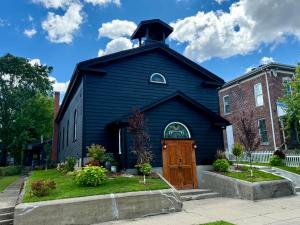a blue church with a steeple on top at Lafayette's Oldest Church in Lafayette