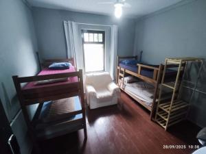 a room with two bunk beds and a window at Republica 947 in Ibirama