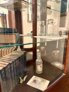 a glass display case with books and a bottle at Lafayette's Oldest Church in Lafayette +73 photos