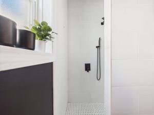 a bathroom with a white door and a sink at Playoff Stay Wrigley 4br Garage Firepit Patio in Chicago +21 photos