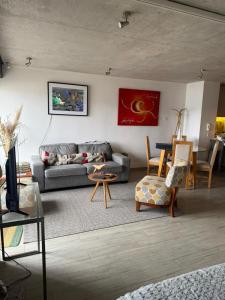 a living room with a couch and a table at HOM Depto 4PAX con Parking En cerro Baron in Valparaíso +22 photos