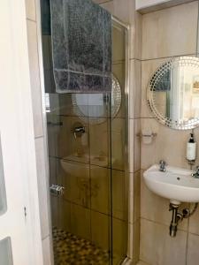 a bathroom with a shower and a sink at Banana Beach Getaway in Port Shepstone