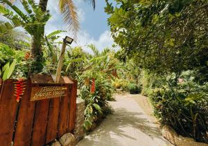 a garden with a sign that reads garden guest house at Buisson Guesthouse in La Digue