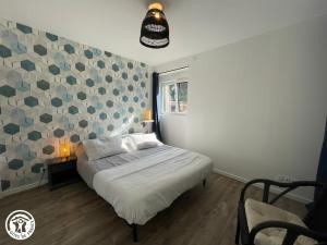 a bedroom with a bed and a wall with tiles at Charmant gîte rural proche du Puy du Fou - FR-1-426-593 in Les Essarts