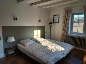 a bedroom with a bed and a window at Maison avec Piscine Privée et Wifi en Dordogne - FR-1-616-501 in Maurens +19 photos