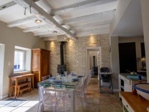a dining room with a table and some chairs at Maison avec Piscine Privée et Wifi en Dordogne - FR-1-616-501 in Maurens
