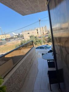 a balcony with a table and a view of a street at Nuns house in Aydūn +4 photos