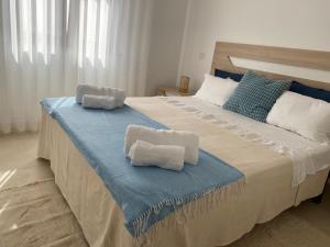 a bedroom with two beds with towels on them at A Casa da Velha in Alvor