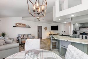 a kitchen and a living room with a table at Spacious Luxury Pool Home Oasis - 8mi to Airport in Palm Bay