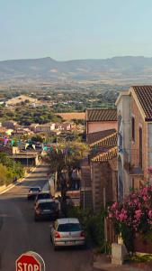 a city street with a stop sign and cars at Sole di Sarda in Badesi