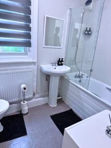 a bathroom with a sink and a shower and a toilet at House for 4 in chatham with free driveway Parking in Chatham