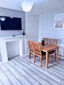 a dining room with a table and two chairs and a television at House for 4 in chatham with free driveway Parking in Chatham