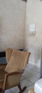 a chair sitting in a room with a wall at Argoat in Locarn