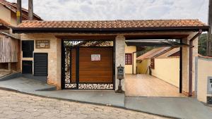 a building with a large wooden door on a street at Casa Luar in Monte Verde