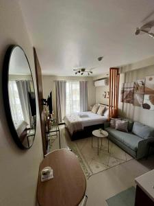 a living room with a bed and a mirror at TheSimsCozyPlace in Suba +10 photos