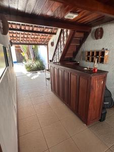 a kitchen with a counter in a room with stairs at Pousada Acquarela Paraty - SOB NOVA DIREÇÃO!!! in Paraty