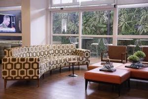 a living room with two couches and a tv at ibis Recife Boa Viagem in Recife