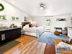 a bedroom with a bed and a sink in it at PNW Scenic Loft with Kitchenette in Philomath