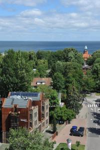 a view of a city with cars parked on a street at Baltica Residence in Sopot