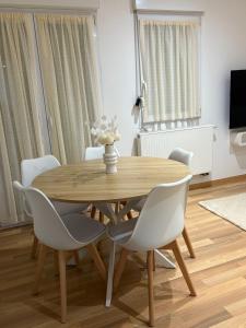 a wooden table and chairs in a living room at LairPure in Villé +6 photos