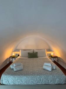 a bedroom with a bed with two pillows on it at MiLù Sicily House in Modica