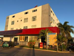 a building with a sign in front of it at Hotel Via Montes in Montes Claros