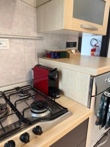 a kitchen with a stove with a coffee maker on it at Nel centro storico di Ovada in Ovada +9 photos