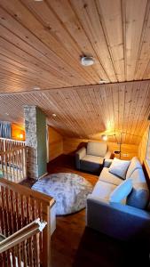 a room with a couch and a bed in a room at Cozy Arctic Lakeside Cottage with private sauna in Pello