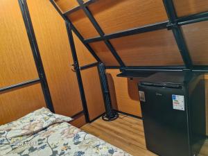 a room with a bed in a room with a poster beduten at Chalé para Casal in Bombinhas +9 photos