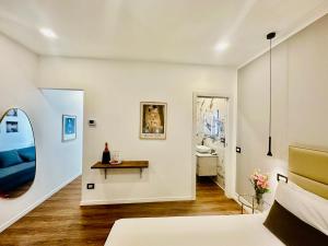 a living room with a blue couch and a mirror at Sweet Rooms in La Spezia