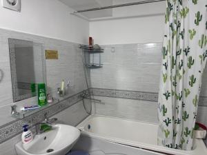 a bathroom with a sink and a tub and a toilet at Xakan City in Andijan