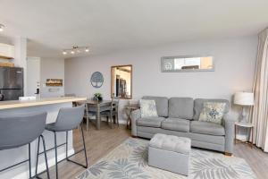 a living room with a couch and a kitchen at Kauhale Makai 212 in Kihei