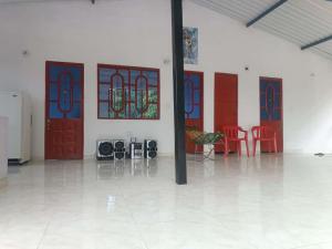 a room with red doors and red chairs and tables at El Mirador del Mango in Apulo