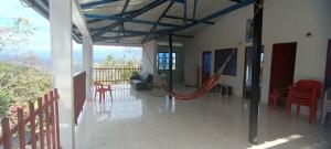 a room with a porch with a hammock in it at El Mirador del Mango in Apulo
