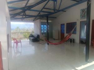 a living room with a hammock in the middle of a room at El Mirador del Mango in Apulo