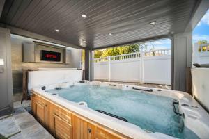 a large jacuzzi tub on a patio at Luxe Family Retreat with Private Pickleball a Large Swim Spa indoor Movie Theatre 2 Outdoor Firepits a Home Gym and more in Lindon