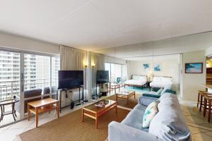 a living room with a couch and a tv at Ilikai Hotel 1133 in Honolulu