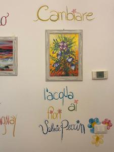 a wall with paintings and words on it at Book Nook Pisa, nei pressi dell'Ospedale di Cisanello e dell'Aeroporto in Cascina