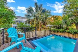 a deck with a chair and a swimming pool at CM4005: 4005 Cameron Blvd. in Isle of Palms