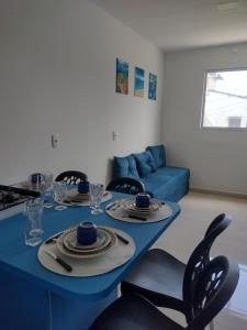 a blue table in a living room with a blue couch at WK Flat em Porto de Galinhas in Porto De Galinhas