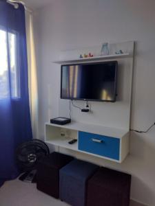 a flat screen tv on a wall in a room at WK Flat em Porto de Galinhas in Porto De Galinhas