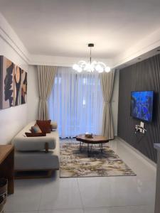 a living room with a couch and a table at Imani Homes in Nairobi