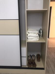 a walk in closet with shoes and a mirror at Imani Homes in Nairobi +4 photos