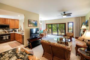 a living room with a couch and a table at Lanikai #212 in Wailua